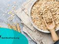 Oat flakes, oats or rolled oats in a bowl on a stone countertop