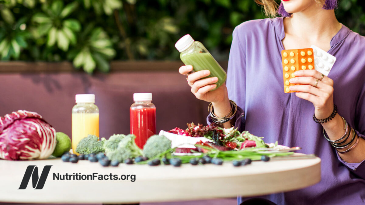 Woman considering vitamins or a juice