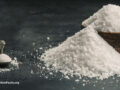 Sweetener piled up around a bowl and a spoon