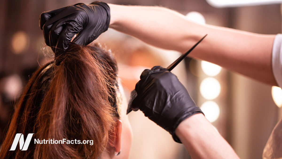 Stylist applying hair dye to client’s hair