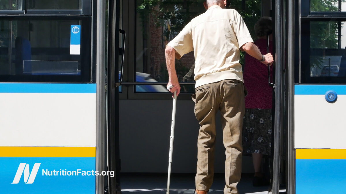 Old man getting on the bus