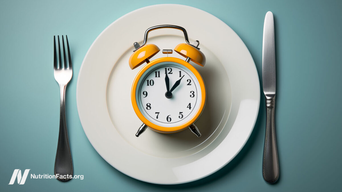Clock on a plate with knife and fork next to